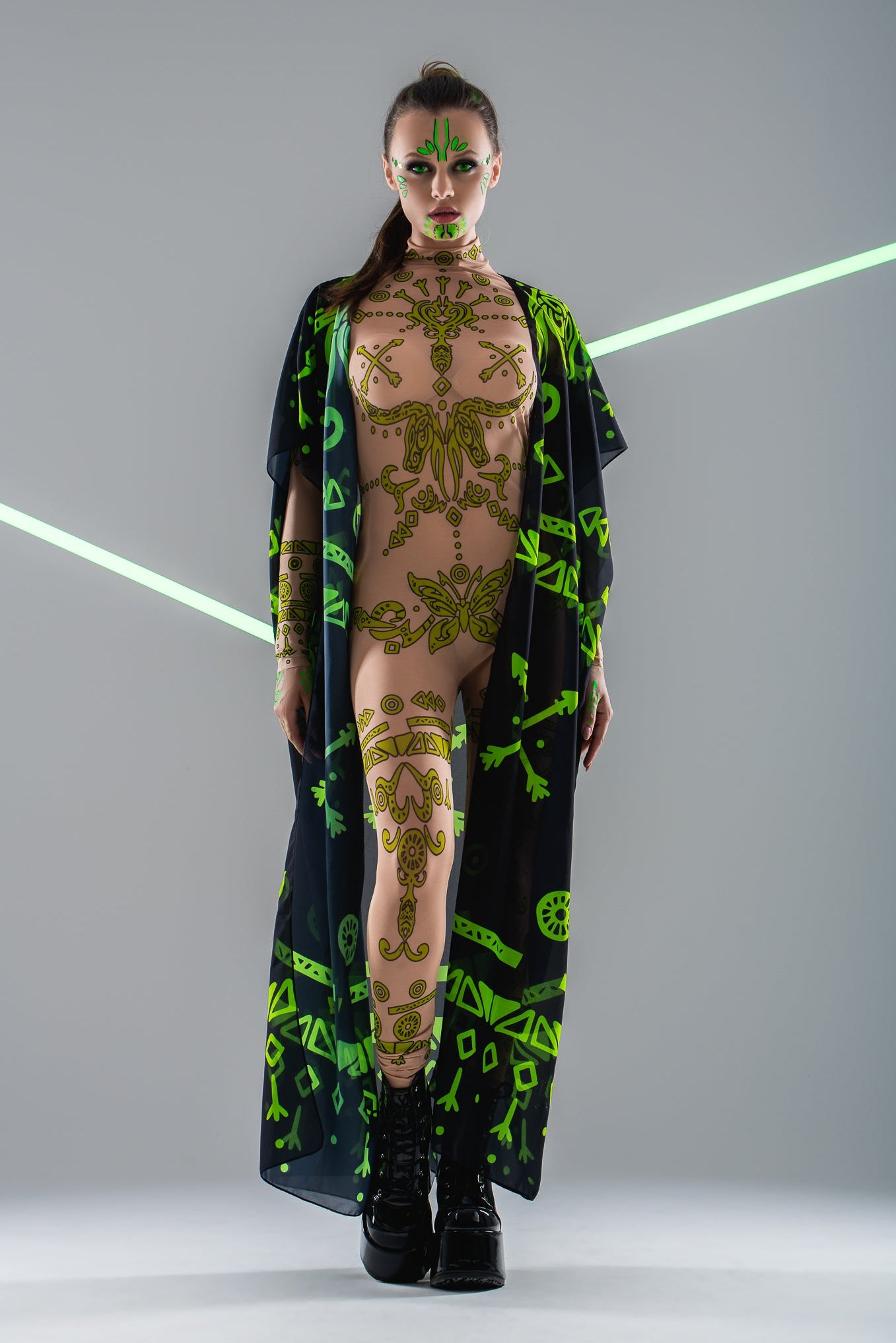 Front view of GREEN TRIBAL Tattoo Catsuit with mesh kimono overlay – combining tribal patterns with a layered look.