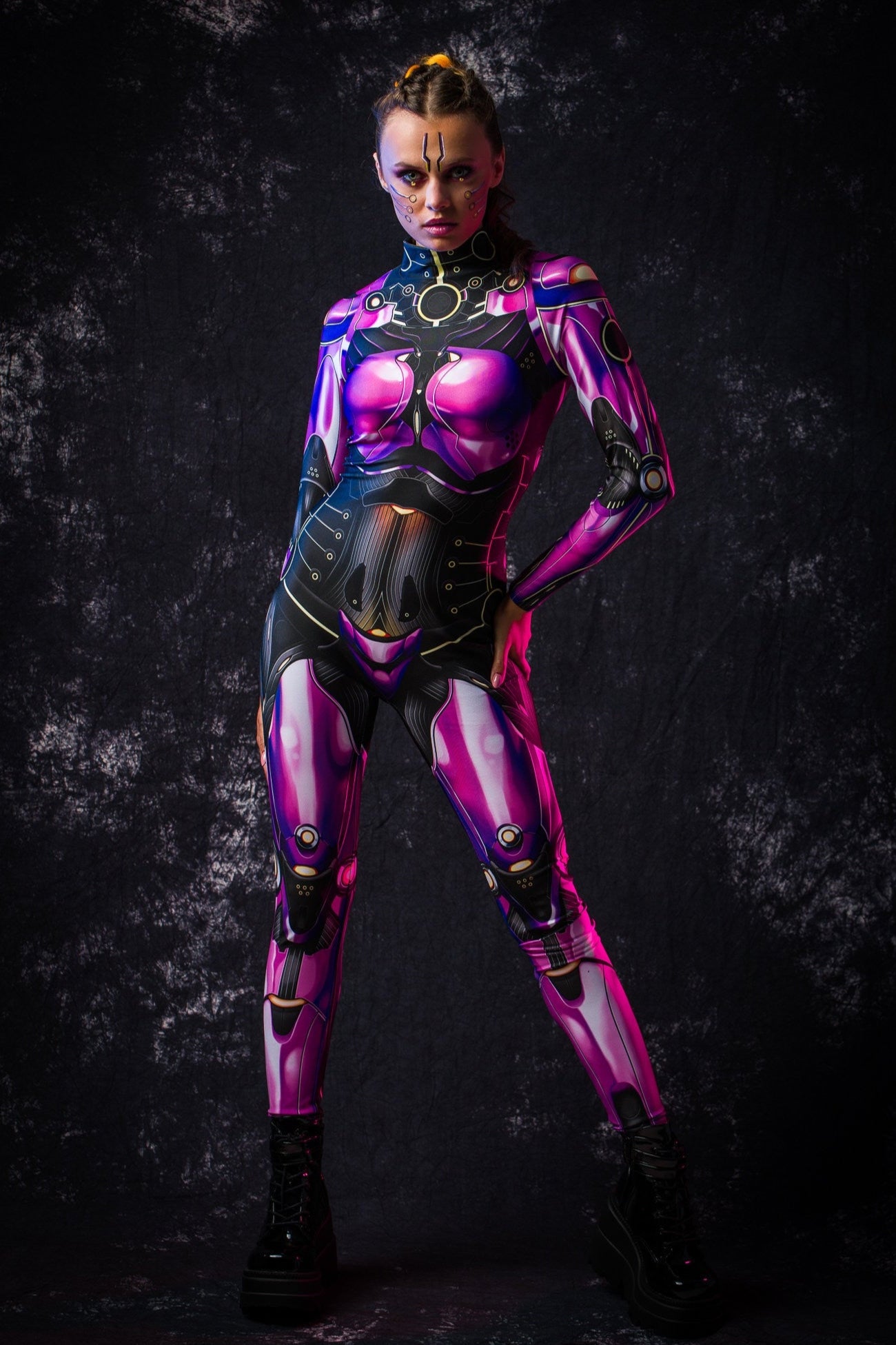 Woman posing dynamically in a violet android catsuit, emphasizing flexibility, style, and futuristic cyberpunk elements of the costume.