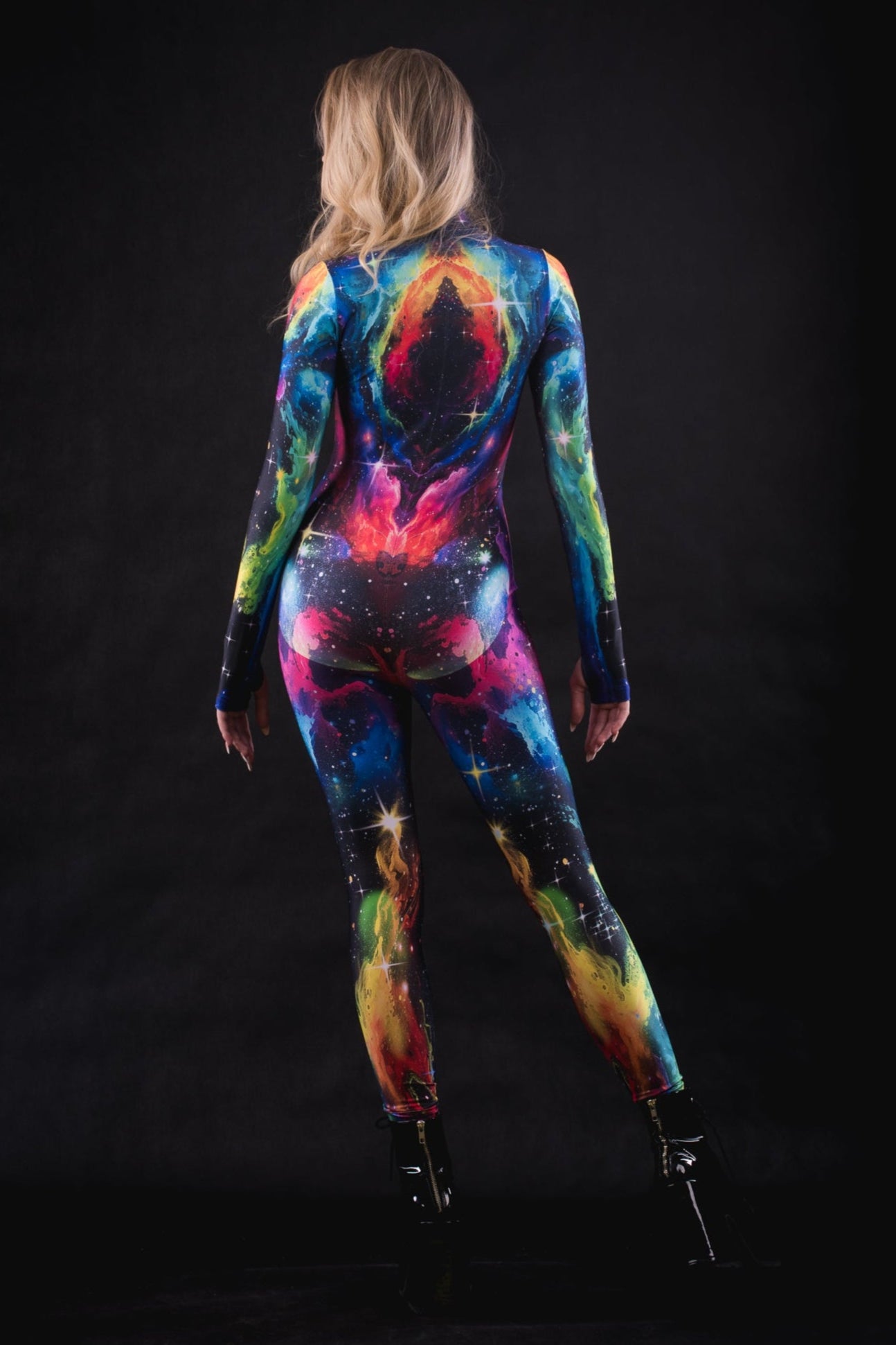 Dynamic back pose of a woman in Galaxy Explorer full body costume, highlighting cosmic print and detailed tailoring for cosplay and themed parties.