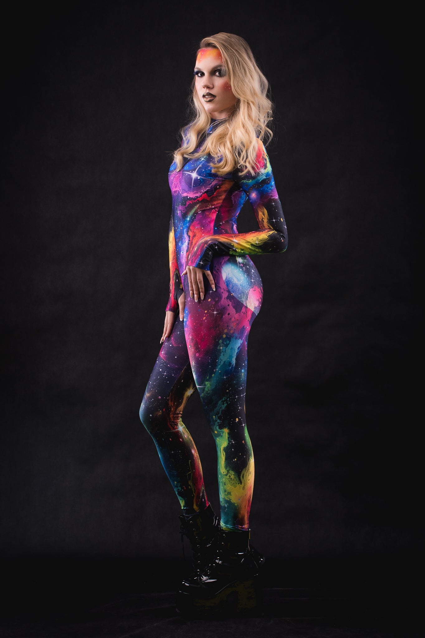 Side profile of a woman wearing Galaxy Explorer catsuit, showcasing the sleek silhouette and cosmic print details in this full body futuristic costume.