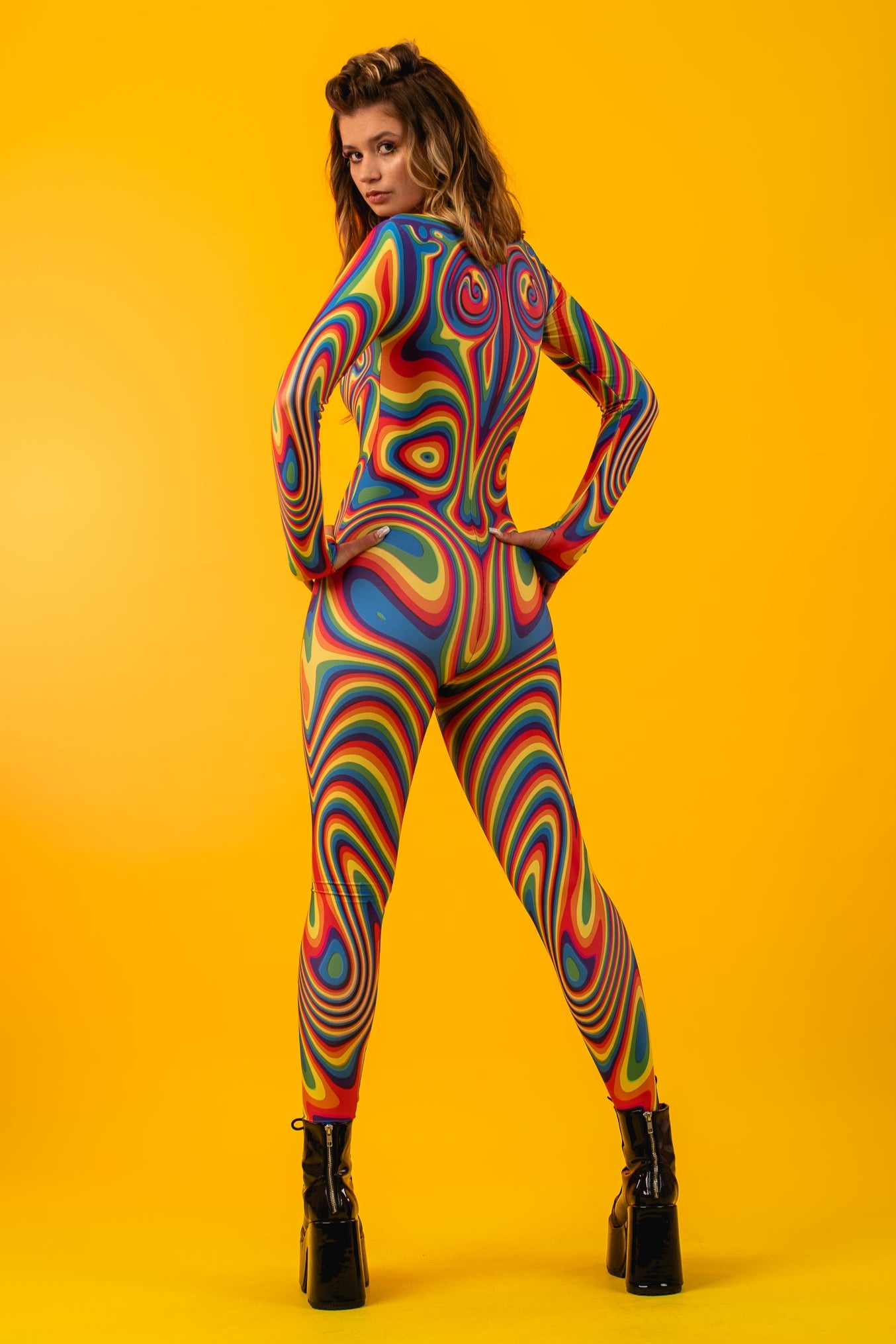 Full back view of Rainbow Liquid Catsuit, showcasing all-over rainbow print and sleek design perfect for raves and Pride events.