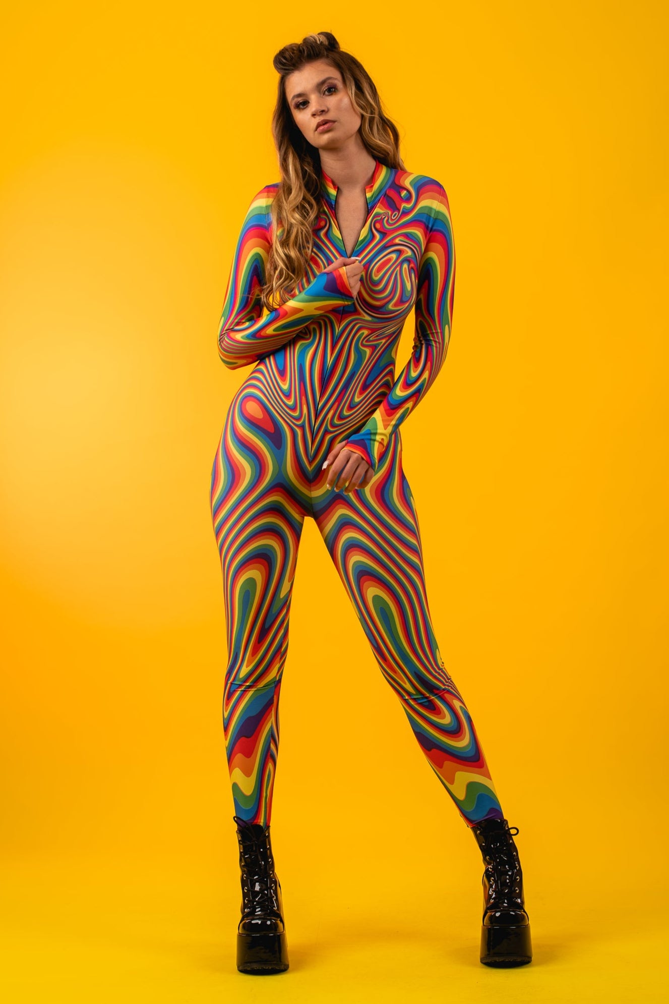 Model shows front zipper of Rainbow Liquid Catsuit, blending functionality with bold rainbow aesthetics perfect for queer festivals.