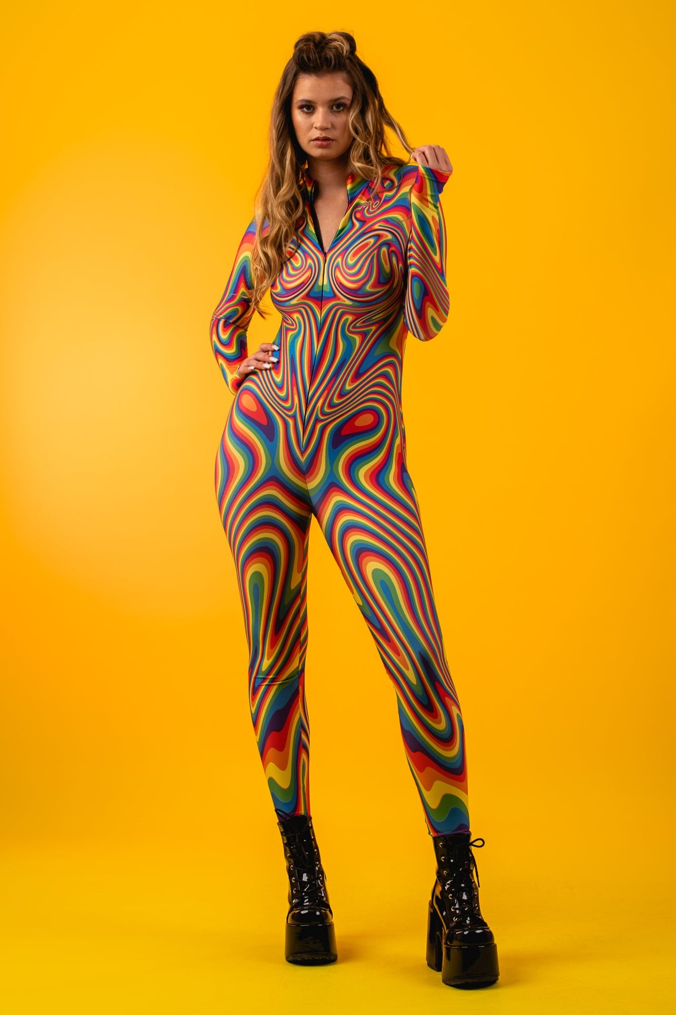Front view of Rainbow Liquid Catsuit with model playing with hair, capturing joyful Pride vibes and colorful self-expression.