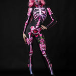 Woman wearing the Pink Sugar Skull Skeleton costume, a pastel pink full-body catsuit with sugar skull accents, ideal for Halloween parties or Day of the Dead events.
