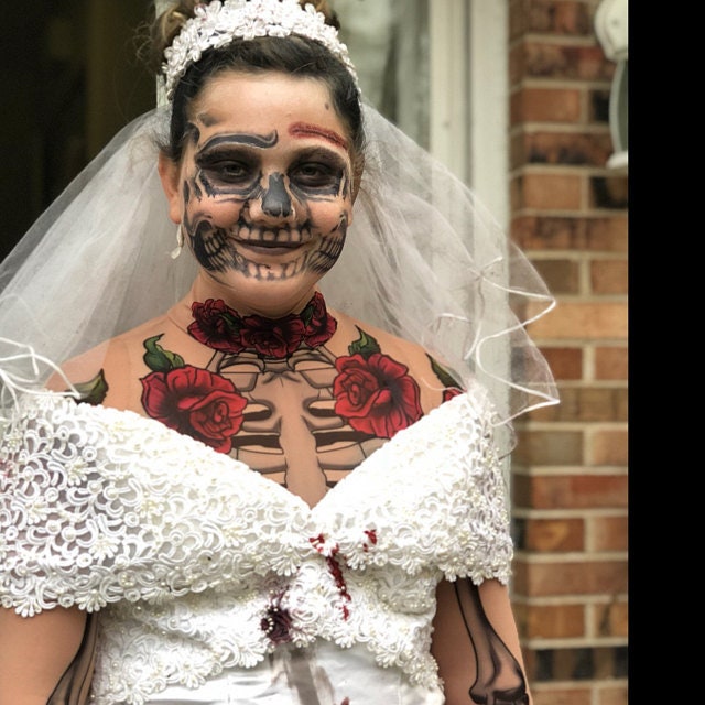 Front view of LADY DEATH Tattoo Skeleton Catsuit for Women – styled with a white dress, highlighting the contrast of tattoo art and elegance.