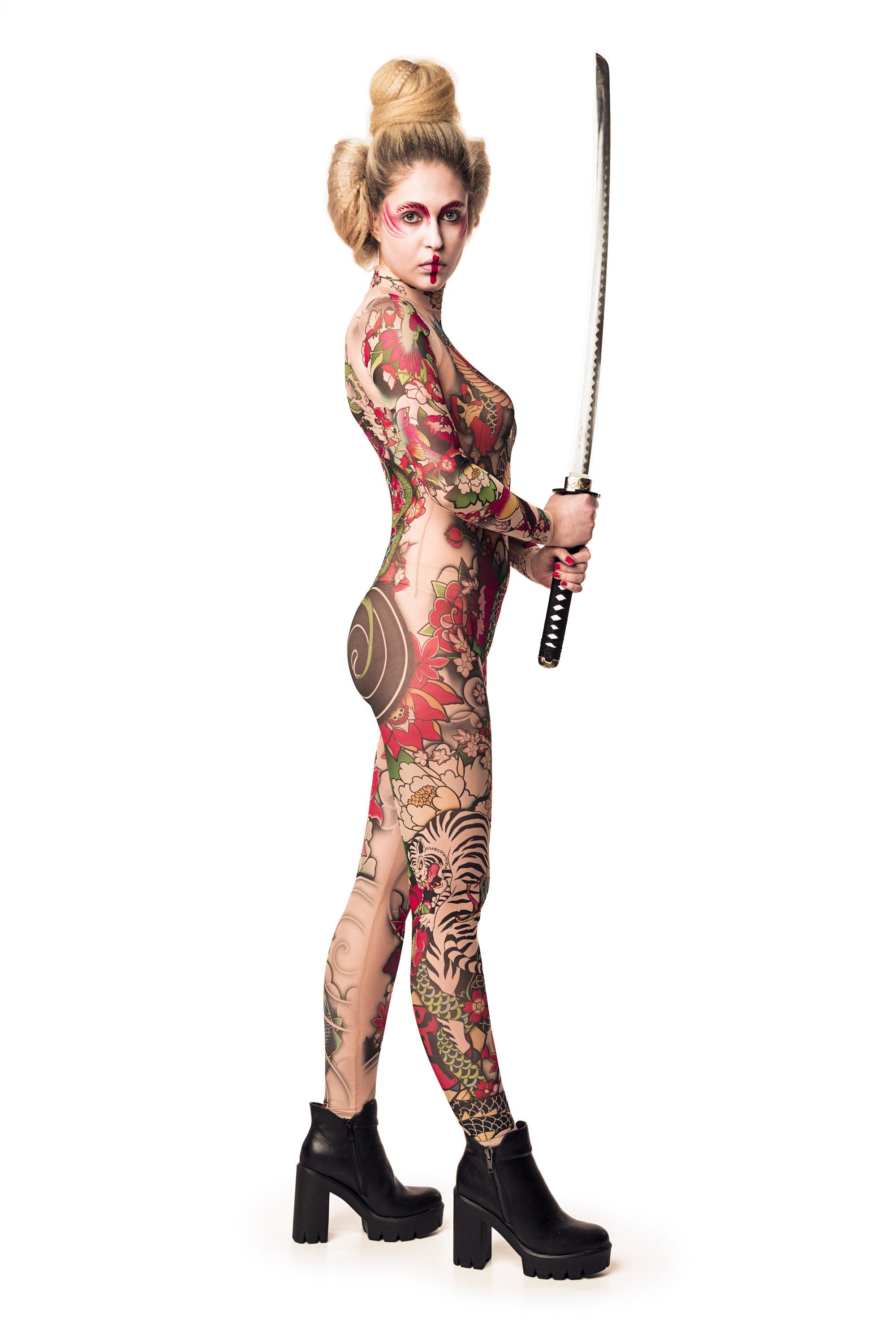 Right side view of YAKUZA STYLE tattoo catsuit, model holding a sword.