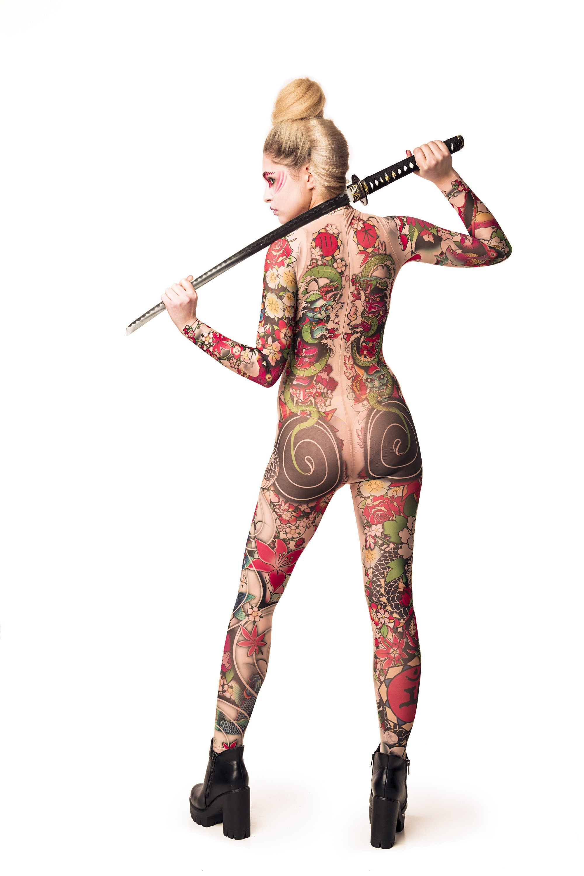 Back view of YAKUZA STYLE tattoo catsuit for women, with the model holding a sword.