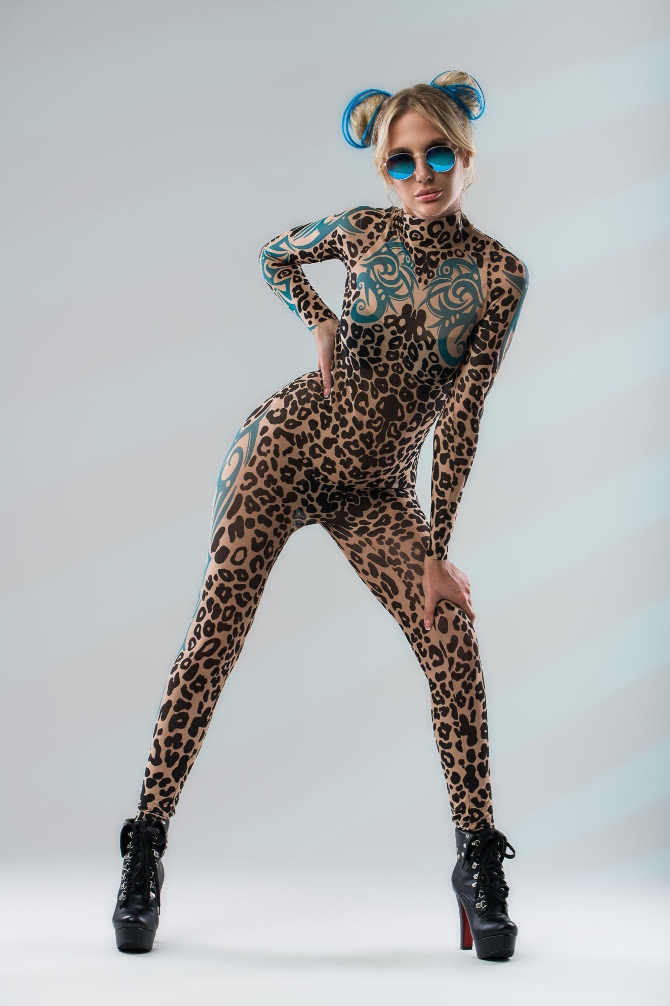 Dynamic front pose with wide stance in LEOPARD SPOTS Tattoo Catsuit for Women – model wearing sunglasses, energetic look.