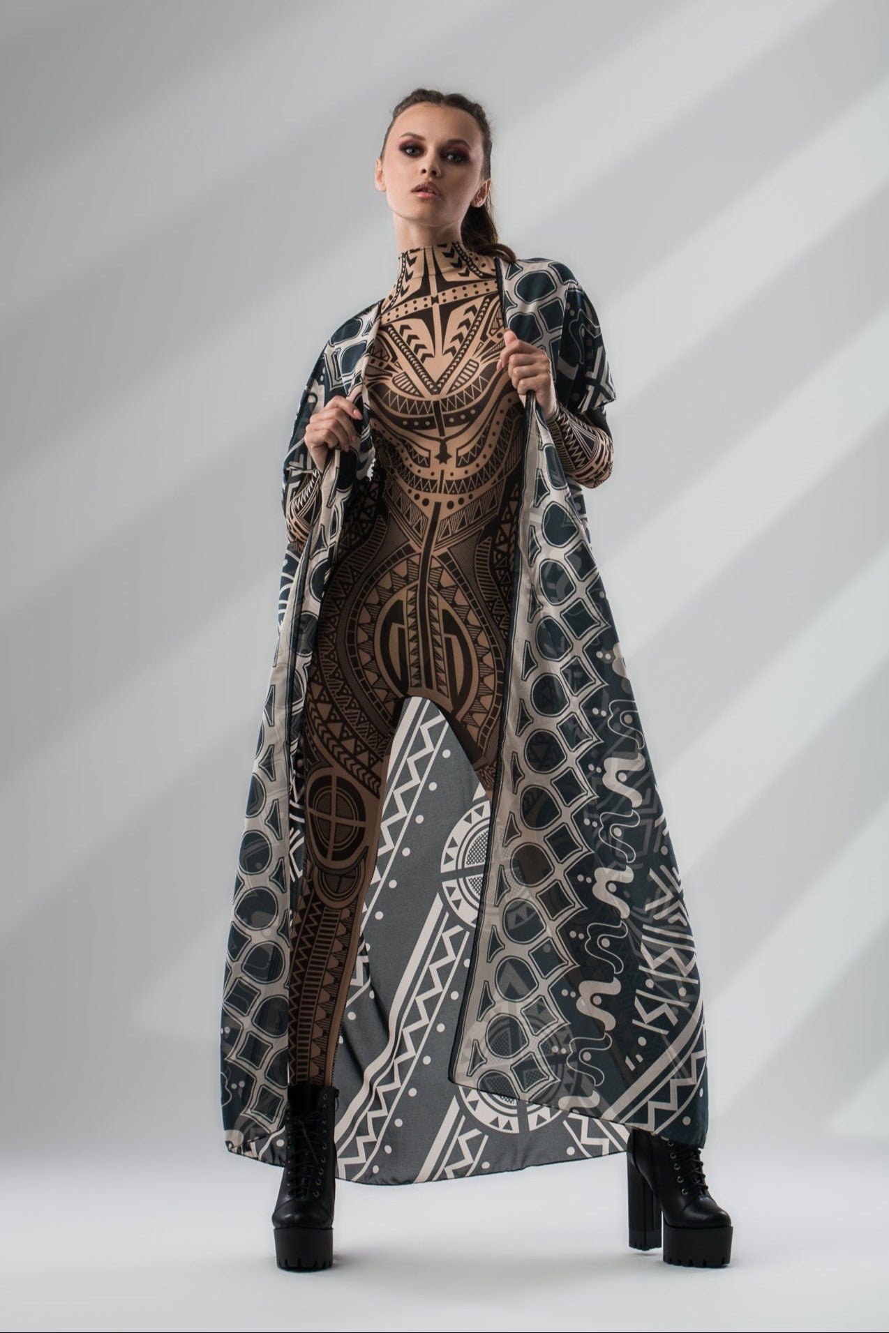 Front view of MAJESTIC TRIBAL Tattoo Catsuit for Women styled with sleeveless kimono – blending bold tribal design with a flowing layer.