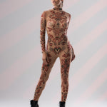 Confident front pose in SCARLET INK Tattoo Catsuit, showcasing intricate tattoo details.