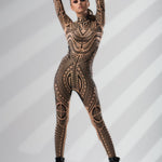 Confident front pose with arms raised in MAJESTIC TRIBAL Tattoo Catsuit for Women – showcasing powerful tribal patterns.