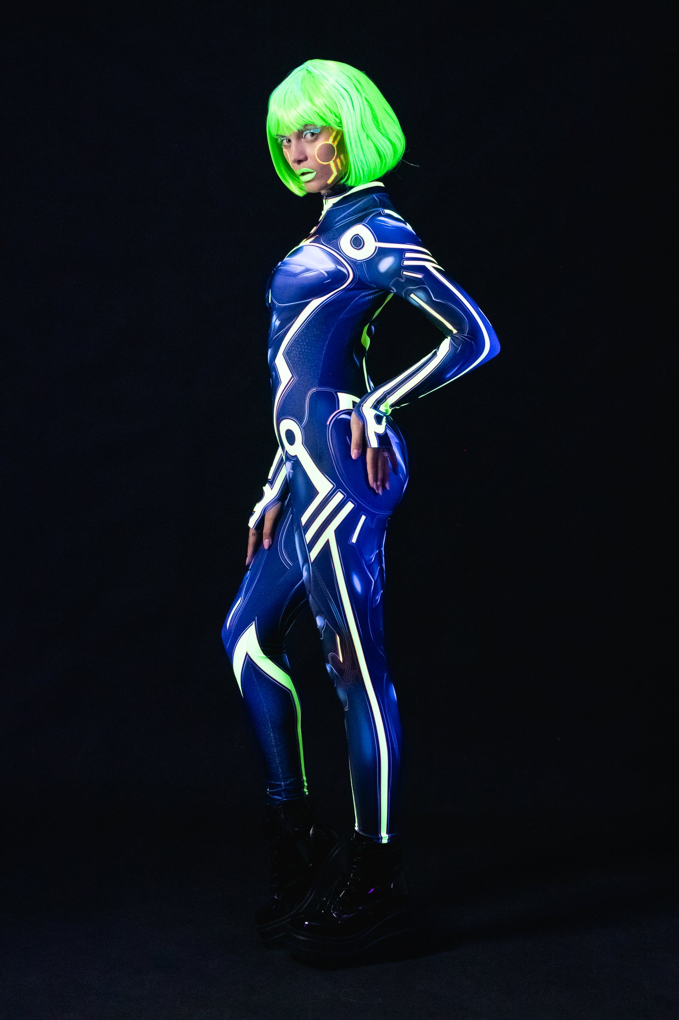 Woman posing in the Cyber Tron UV Reactive costume, highlighting the futuristic design and UV-reactive neon glow, great for festivals, raves, or Halloween.