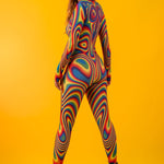 Rear view of the Rainbow Liquid Catsuit with model turning her head, highlighting playful elegance and full body rainbow design.
