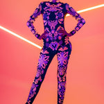 Front view of the SUNSET VOLTAGE UV Reactive Catsuit glowing under blacklight – bold fluorescent design perfect for raves and festivals.