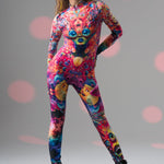 Model in TRIPPY DREAM Catsuit strikes a proud dynamic front pose, highlighting striking psychedelic design and confident style.