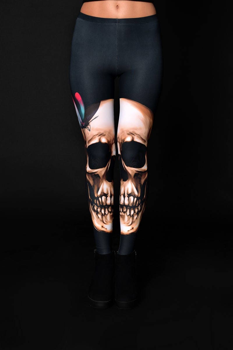 Woman posing in Skull Butterflies Halloween leggings, showcasing the unique skull and butterfly design, perfect for Halloween or as a statement piece in gothic fashion.