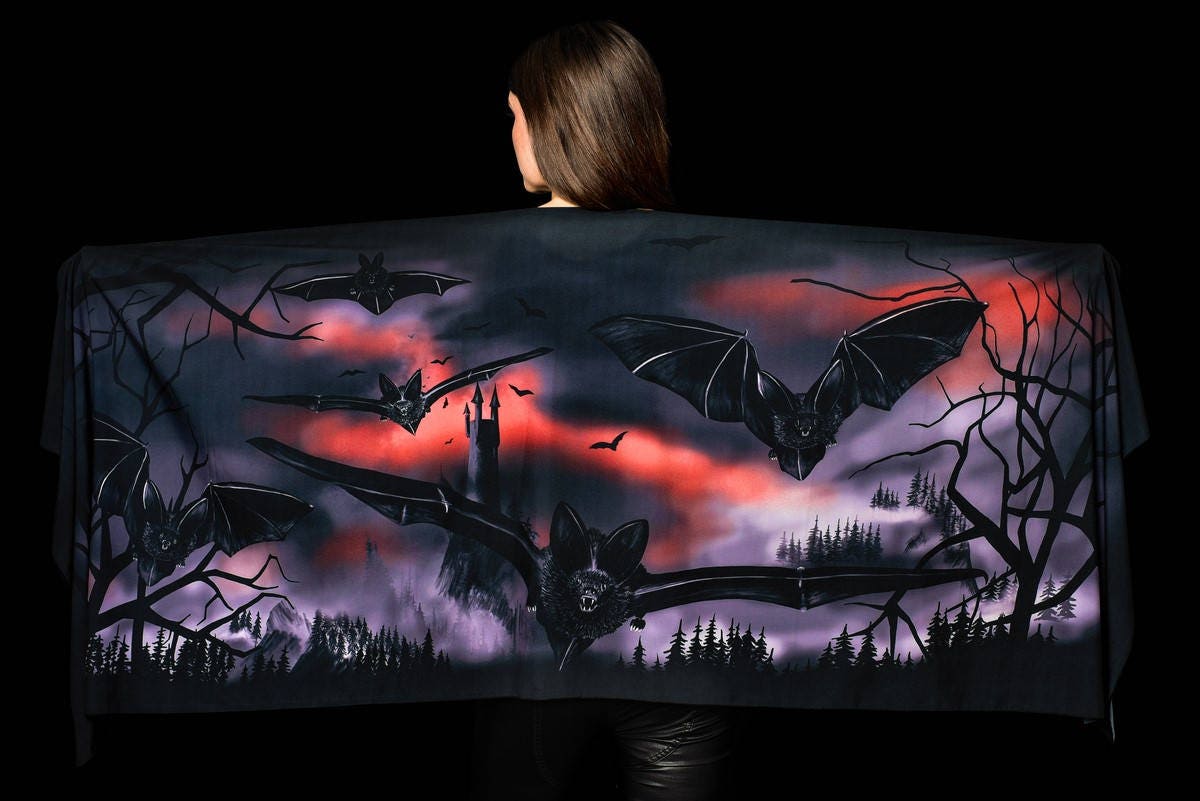 Model wearing the Castle Bats Halloween scarf, showcasing the intricate castle and bat print, perfect for Halloween or as a stylish vampire-themed shawl.