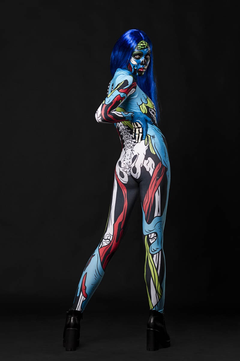 Person wearing the Zombie Skeleton costume, a full-body suit with comic-style blue skeleton and zombie details, perfect for Halloween or cosplay.