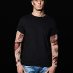 Man posing in the Spiders Halloween T-shirt with tattoo sleeves, showcasing the spooky spiderweb and bloody tattoo design, perfect for Halloween or as a unique statement shirt.