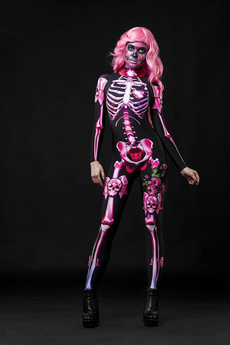 Pink Sugar Skull Skeleton Halloween costume for women, featuring a pastel pink skeleton catsuit with sugar skull details, perfect for Halloween or Day of the Dead celebrations.