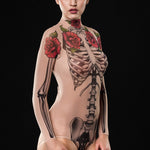 Woman wearing the Tattoo Skeleton bodysuit, featuring a detailed skeleton and tattoo design, perfect for Halloween parties or gothic-themed festivals.