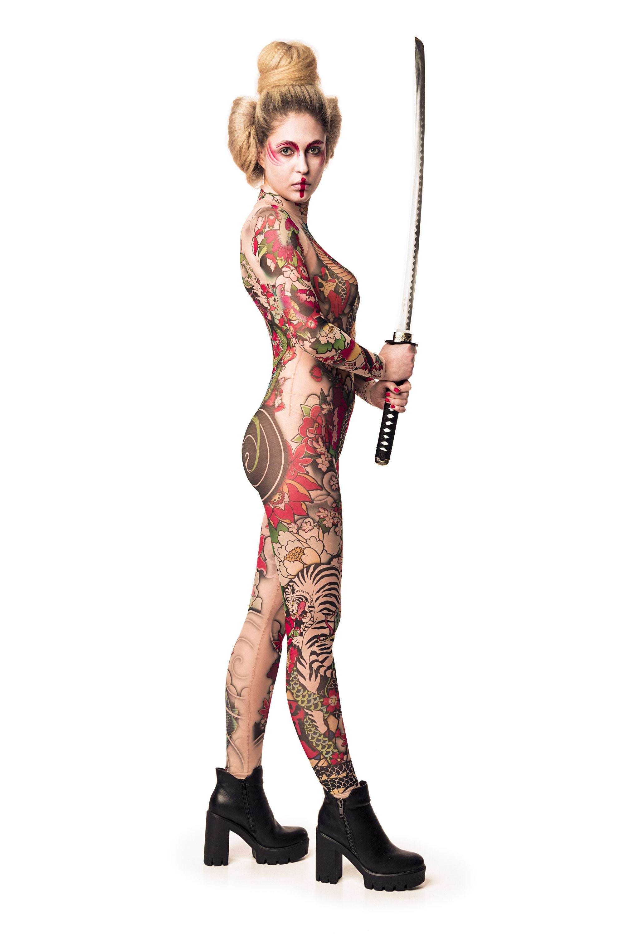 Close-up of the Japanese tattoo-style design on the Yakuza-style mesh catsuit, with the model holding a sword, ideal for a bold Halloween or festival look.