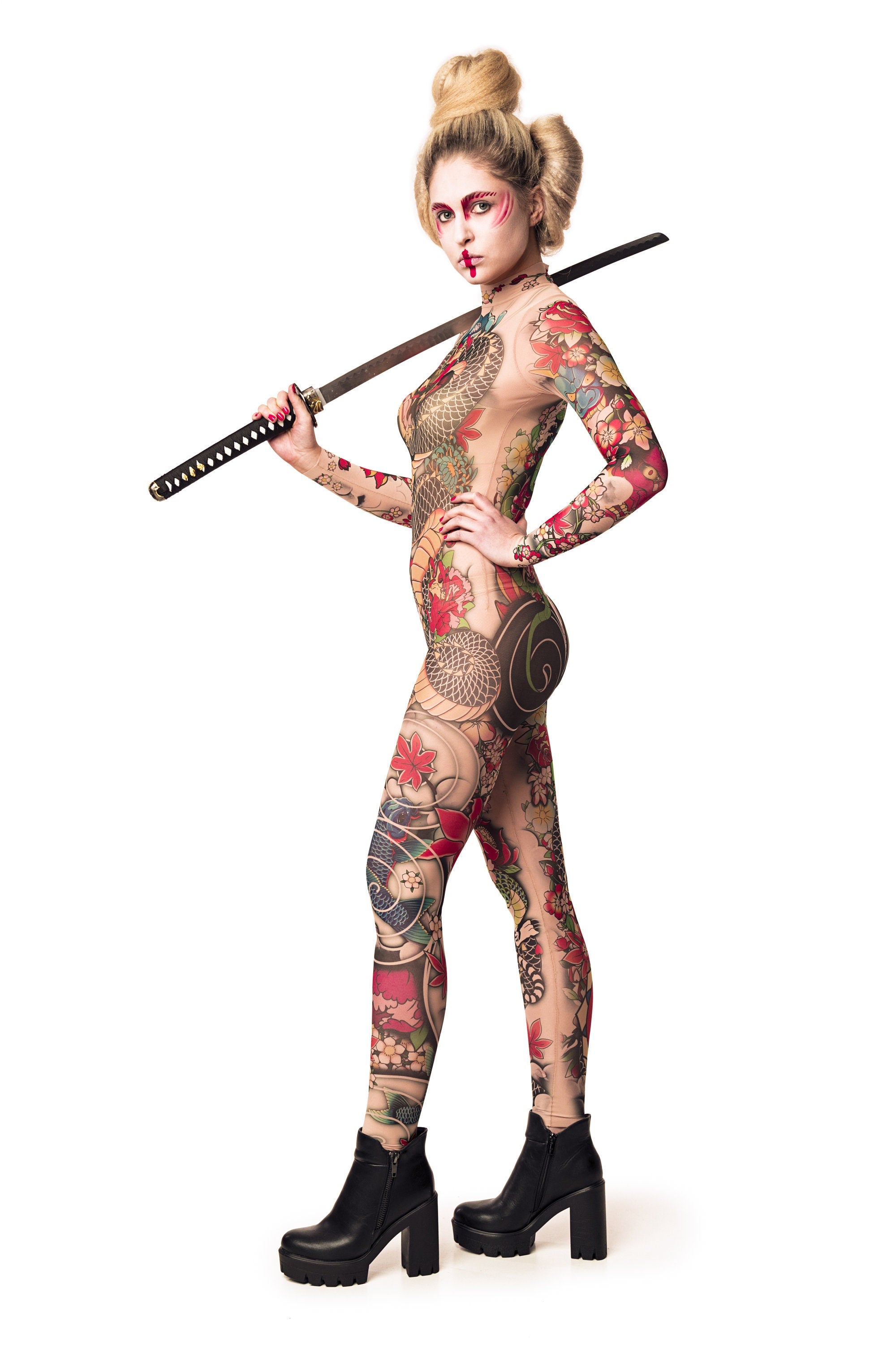 Woman posing in the Yakuza Style Tattoo Halloween catsuit, holding a sword and showcasing the intricate Japanese tattoo-inspired design on mesh, great for Halloween or as a standout festival outfit.