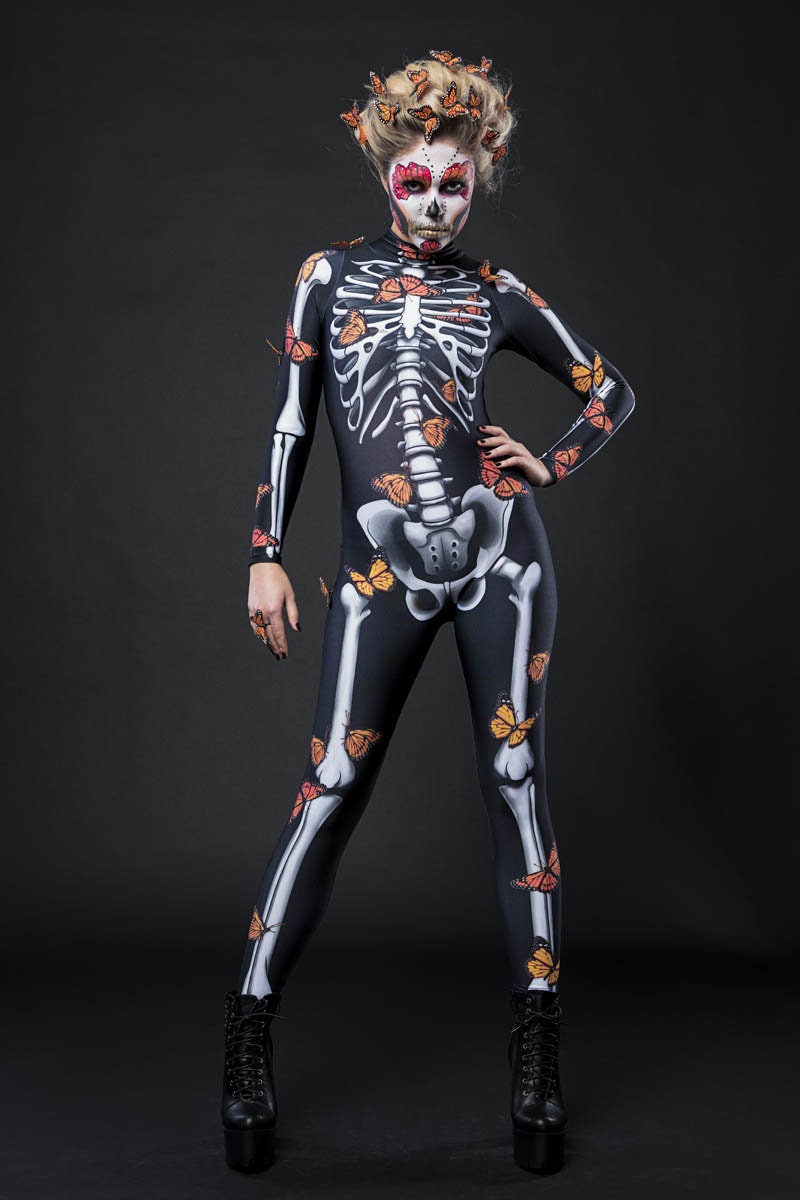 Woman posing in the Lady Butterfly Skeleton costume, showcasing vibrant butterfly wings and a skeleton theme, perfect for Halloween or as a standout festival outfit.