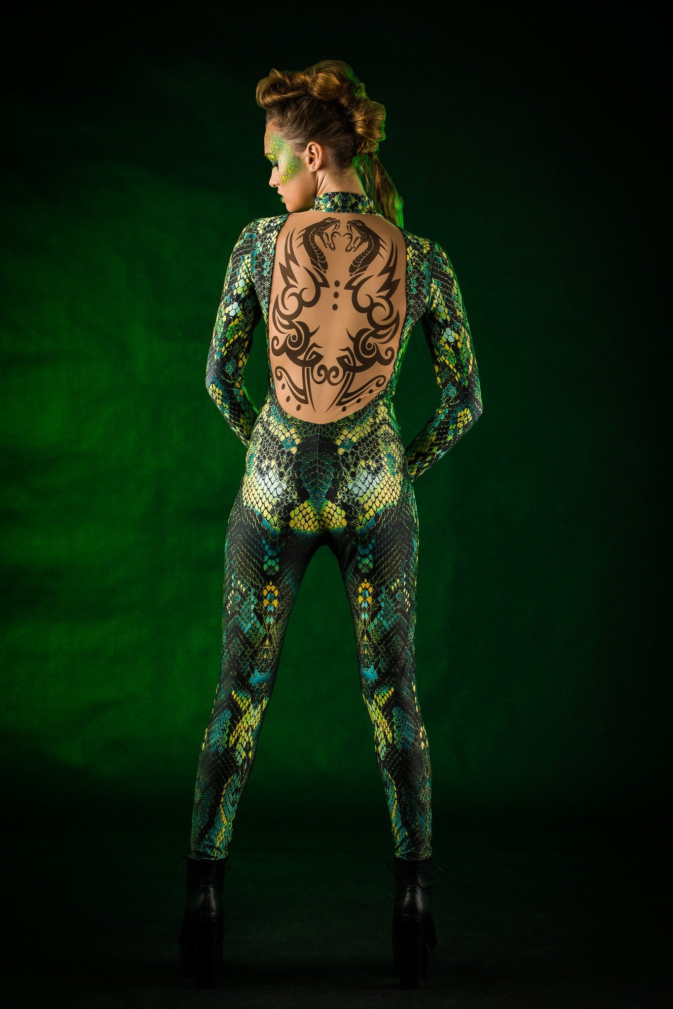 Woman posing in the Green Snake Halloween costume, highlighting the sleek green snake skin design and tattoo effect, great for Halloween events or as a unique festival outfit.