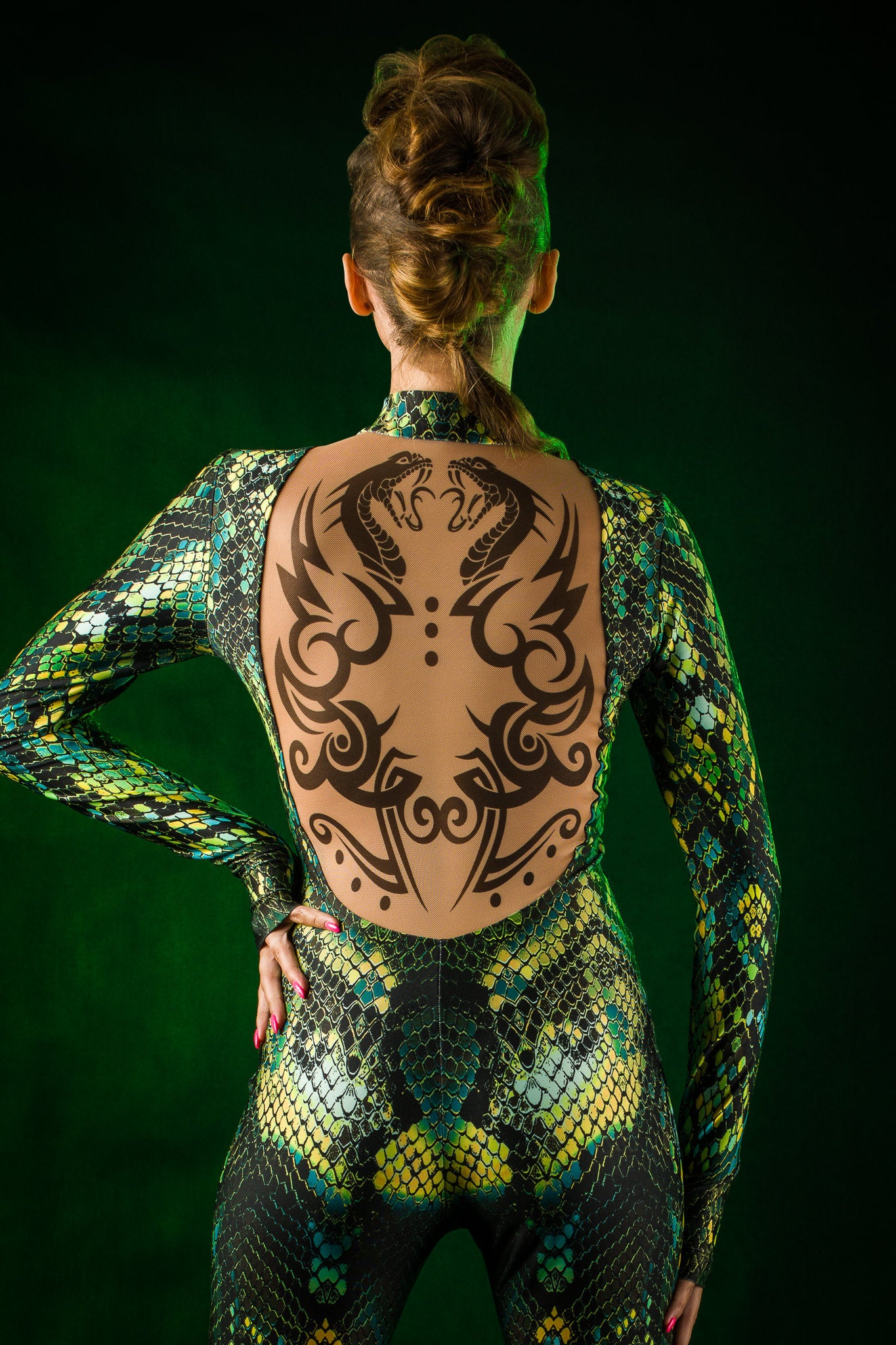 Close-up of the tattoo effect and green snake skin pattern on the Green Snake jumpsuit, perfect for a bold Halloween look or festival fashion.