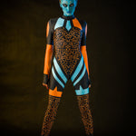 Woman posing in the Blue Alien Halloween costume, showcasing the sleek blue jumpsuit and tattoo effect, great for Halloween or as a standout festival outfit.