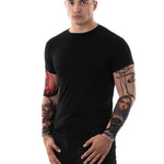 Man posing in the Zombie Circus Halloween T-shirt with tattoo sleeves, showcasing the detailed zombie and circus tattoo prints, great for Halloween or as a casual statement top.