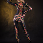 Close-up of the vibrant orange, yellow, and green skeleton design with flower details on the full-body catsuit, ideal for Halloween or festival wear.