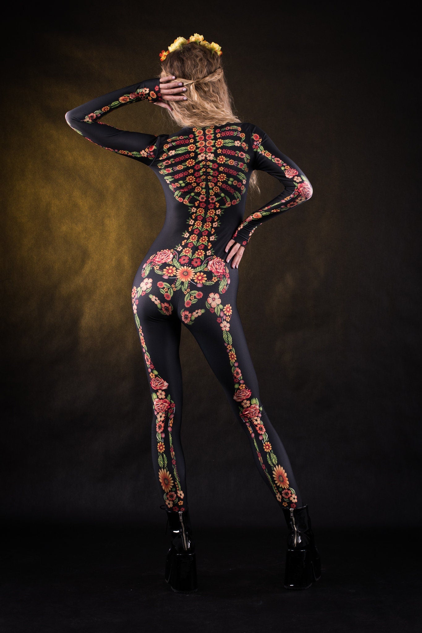 Close-up of the vibrant orange, yellow, and green skeleton design with flower details on the full-body catsuit, ideal for Halloween or festival wear.