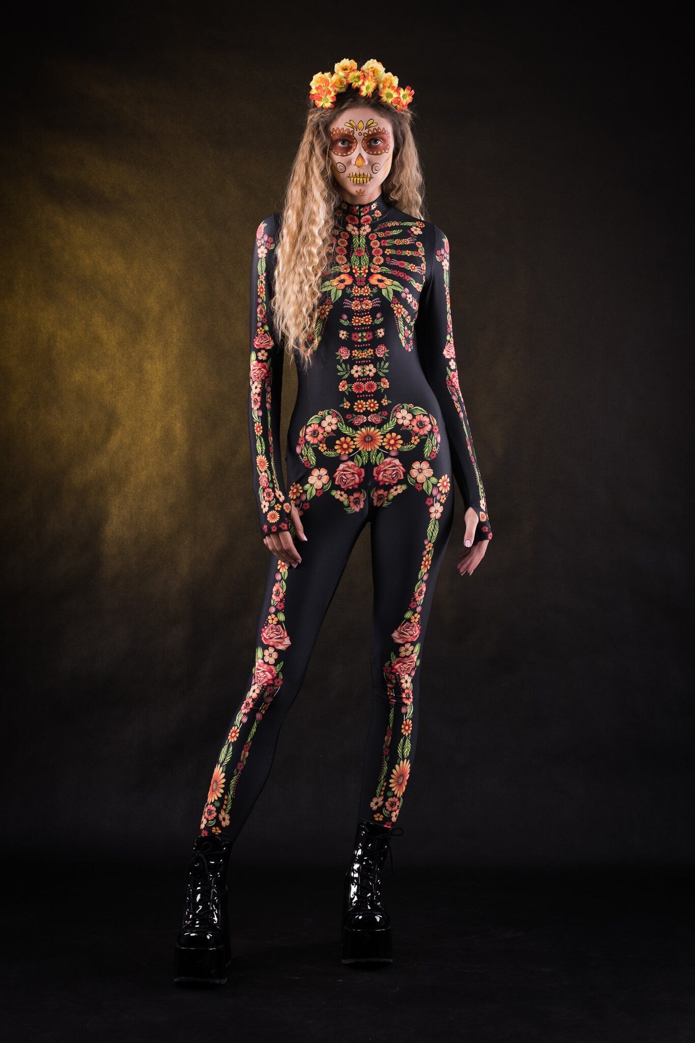 Woman posing in the Flower Skeleton costume, showcasing the colorful skeleton design with orange, yellow, and green floral patterns, great for Halloween or as a standout festival outfit.