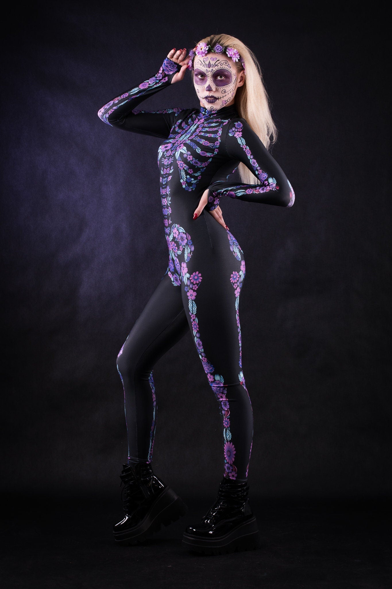 Woman posing in the Flower Skeleton costume, showcasing vibrant purple and blue skeleton design with flowers, ideal for Halloween or as a striking festival outfit.