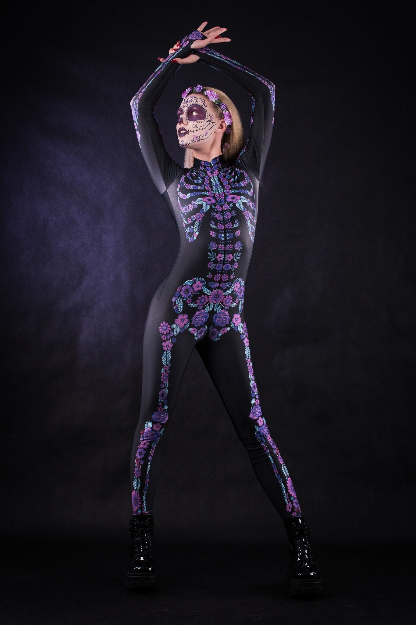 Woman posing in the Flower Skeleton costume, showcasing vibrant purple and blue skeleton design with flowers, ideal for Halloween or as a striking festival outfit.