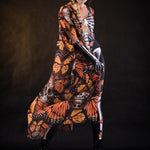 Woman posing in the Orange Monarchy Butterflies Halloween kimono cape, showcasing the bold butterfly design and elegant flow, ideal for Halloween parties or as a statement festival piece.