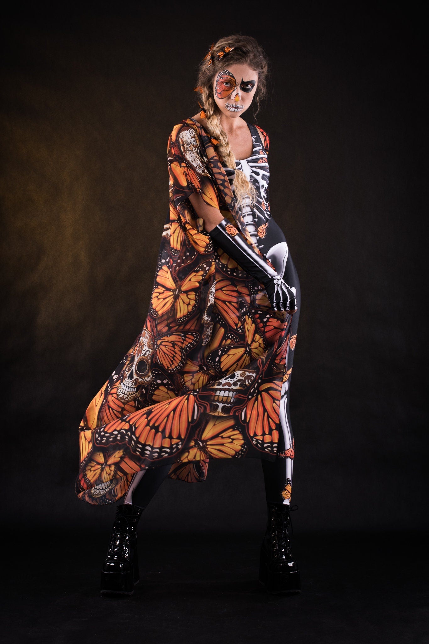 Woman posing in the Orange Monarchy Butterflies Halloween kimono cape, showcasing the bold butterfly design and elegant flow, ideal for Halloween parties or as a statement festival piece.