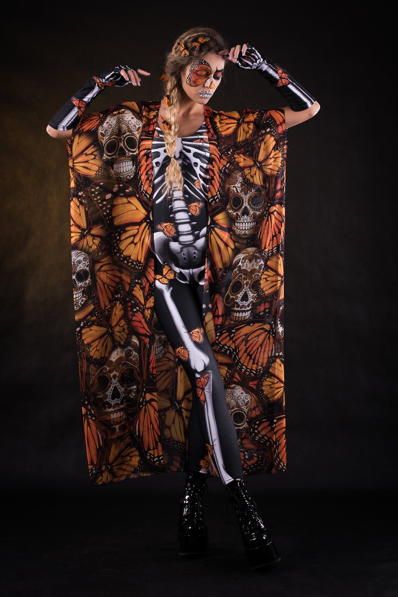 Woman posing in the Orange Monarchy Butterflies Halloween kimono cape, showcasing the bold butterfly design and elegant flow, ideal for Halloween parties or as a statement festival piece.