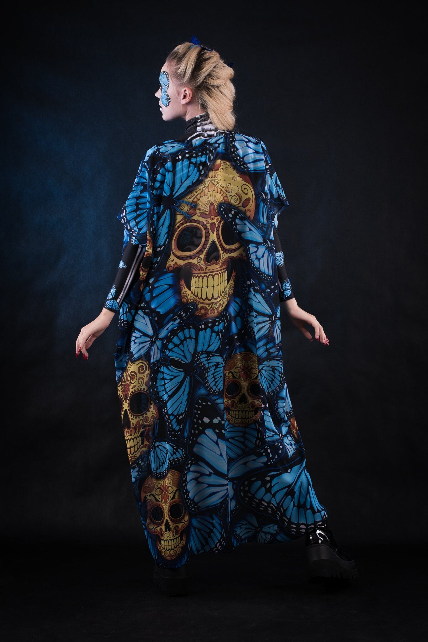 Woman posing in the Lady Blue Butterfly skeleton costume, highlighting the vibrant blue butterfly design, skeleton theme, and flowing kimono, great for Halloween or as a unique festival outfit.