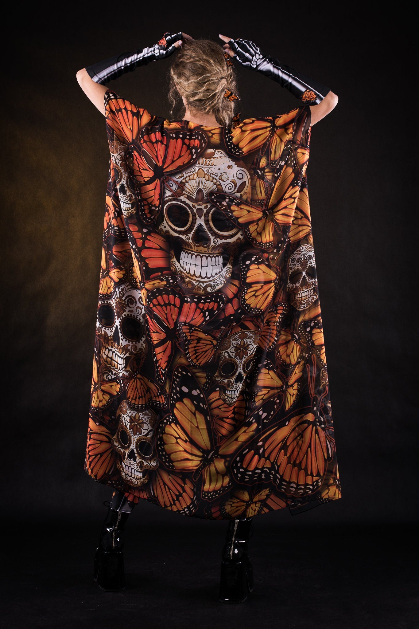 Woman posing in the Orange Butterflies Skeleton jumpsuit with kimono, highlighting the detailed butterfly and skeleton design, great for Halloween parties or as a standout festival outfit.