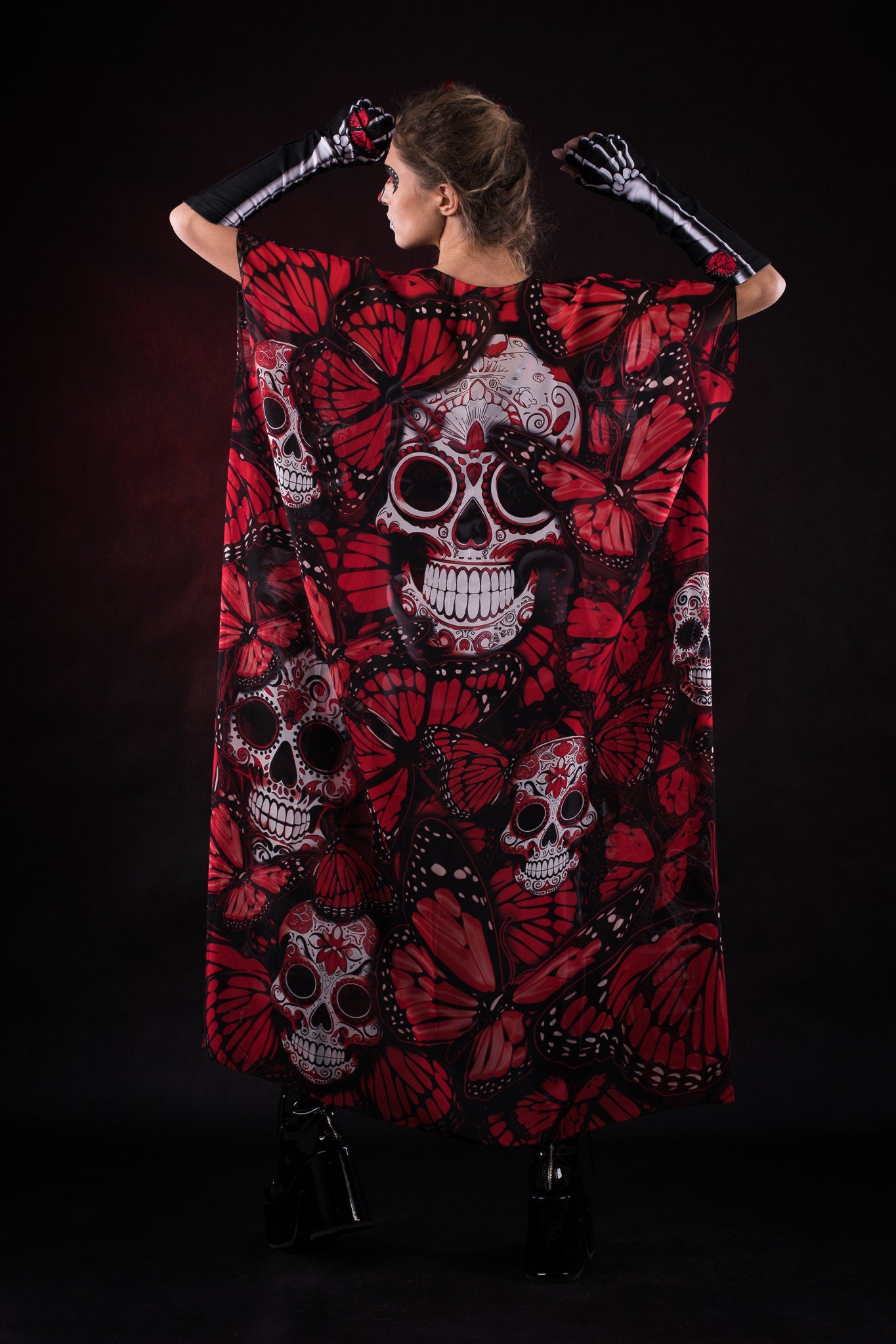 Close-up of the intricate skeleton design with red butterfly details on the jumpsuit and kimono set, ideal for Halloween or Day of the Dead celebrations.