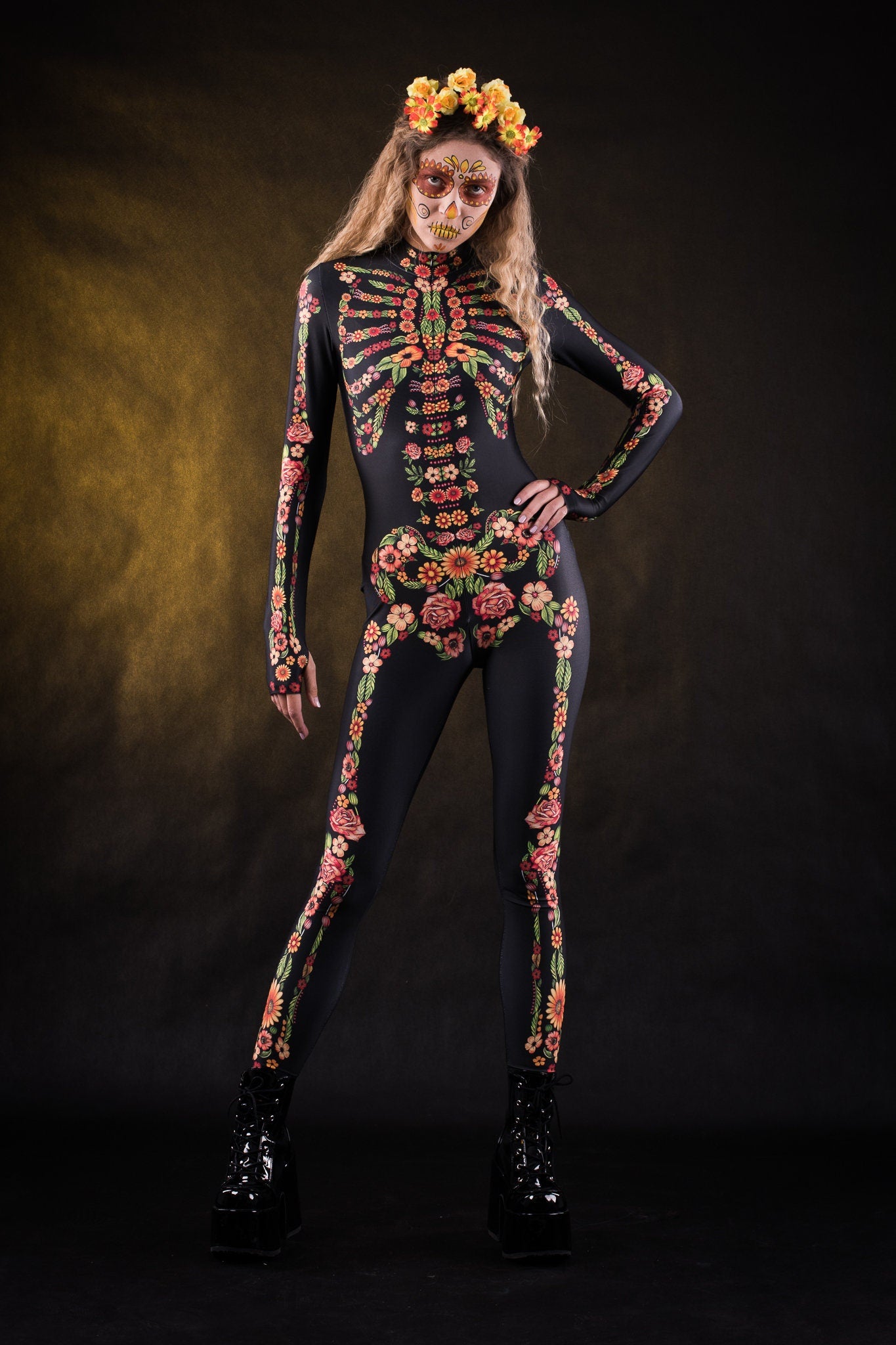 Woman posing in the Flower Skeleton costume, showcasing the colorful skeleton design with orange, yellow, and green floral patterns, great for Halloween or as a standout festival outfit.