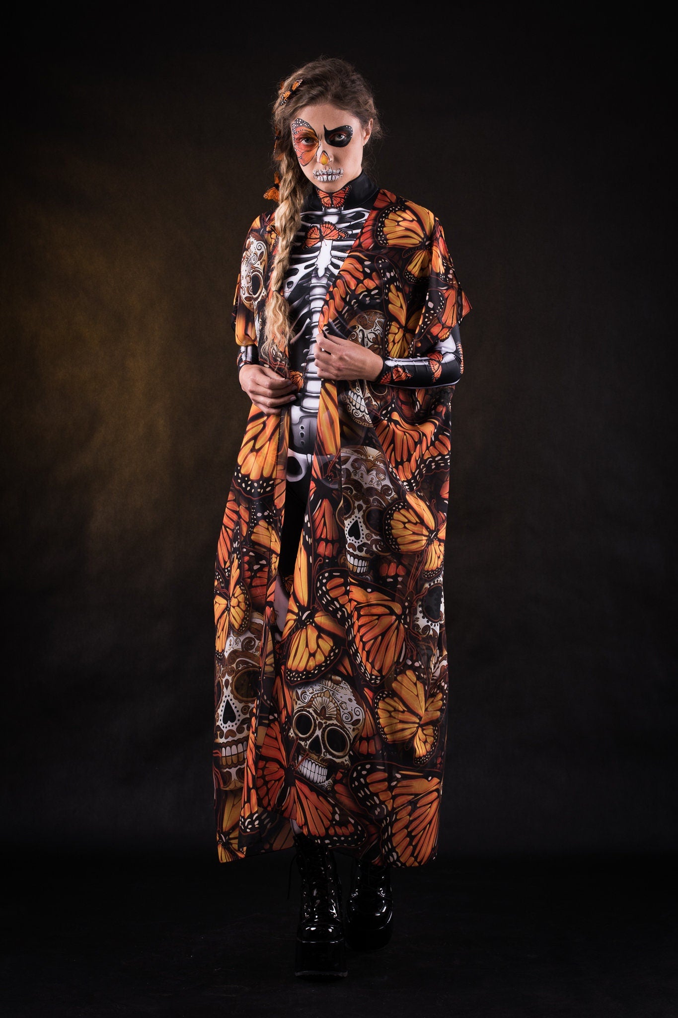 Woman wearing the Lady Orange Butterfly skeleton costume, featuring a colorful kimono with vibrant orange butterfly accents, perfect for Halloween parties or Day of the Dead events.