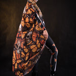 Woman posing in the Orange Monarchy Butterflies Halloween kimono cape, showcasing the bold butterfly design and elegant flow, ideal for Halloween parties or as a statement festival piece.