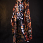 Woman wearing the Orange Monarchy Butterflies kimono cape, featuring detailed butterfly accents, perfect for Day of the Dead or Halloween events.