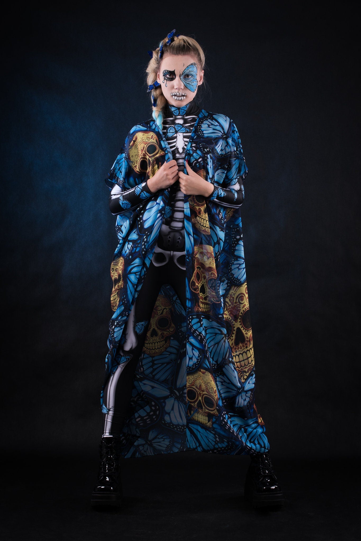 Woman posing in the Lady Blue Butterfly skeleton costume, highlighting the vibrant blue butterfly design, skeleton theme, and flowing kimono, great for Halloween or as a unique festival outfit.