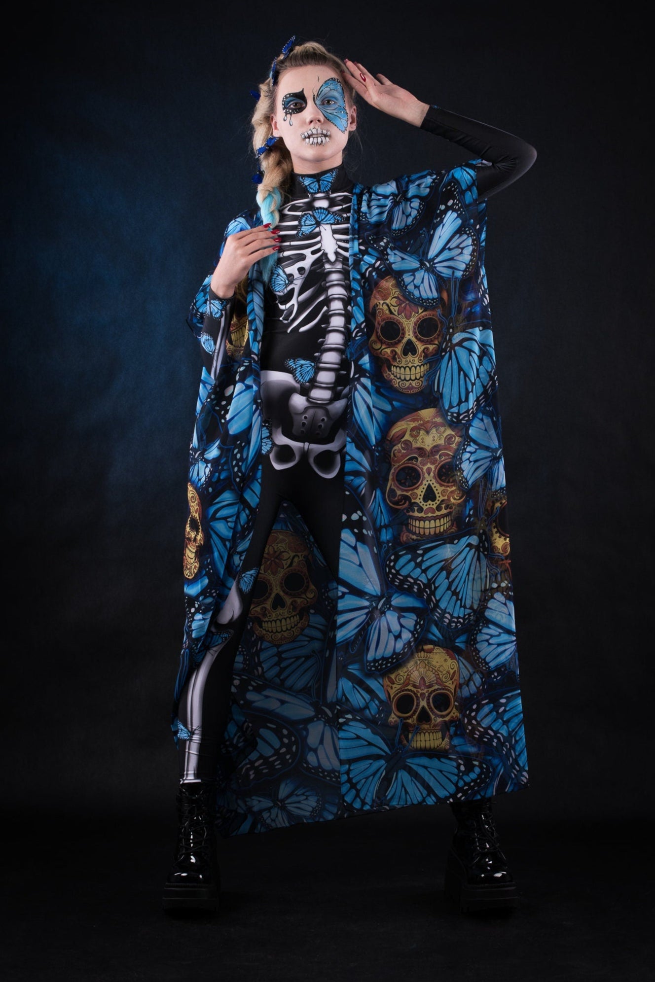 Close-up of the intricate blue butterfly prints on the Blue Monarchy kimono cape, showcasing the delicate design and ethereal style. Festival, dance music.