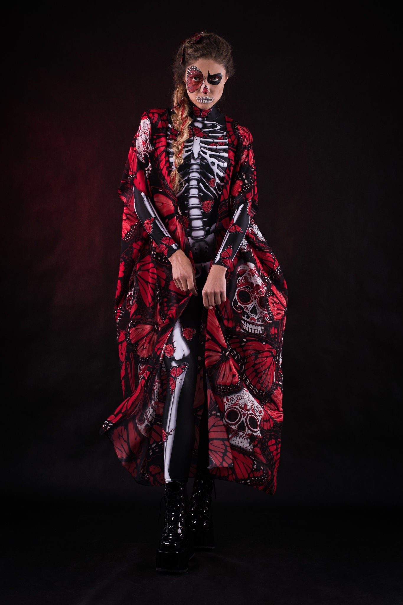 Woman wearing the Lady Red Butterfly skeleton costume, featuring a colorful kimono with red and blue butterfly accents, perfect for Halloween parties or Day of the Dead events.